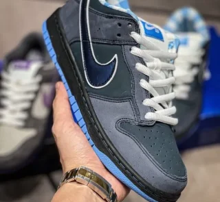 Blue Lobster Dunk Reps handheld side view showing dark navy suede upper
