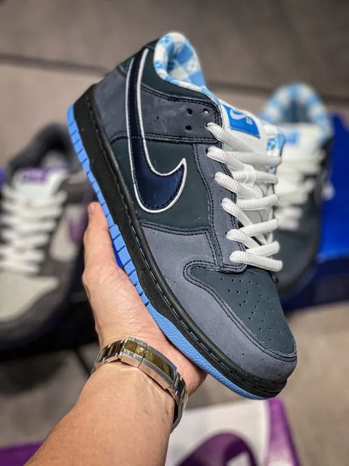 Blue Lobster Dunk Reps handheld side view showing dark navy suede upper