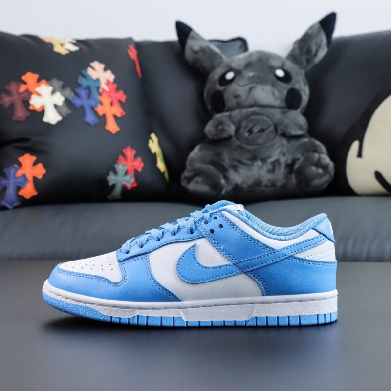 Single shoe side view of UNC Dunk Low replica with clean white base