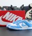 UNC Dunks Reps with powder blue and white colorway placed in front of box