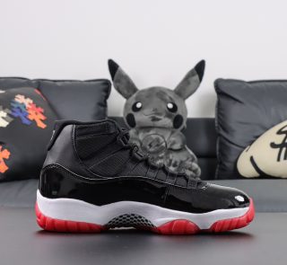 Side view of Jordan 11 Bred replica with red sole and OG black upper