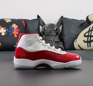Side view of Jordan 11 Cherry reps in white and varsity red combination