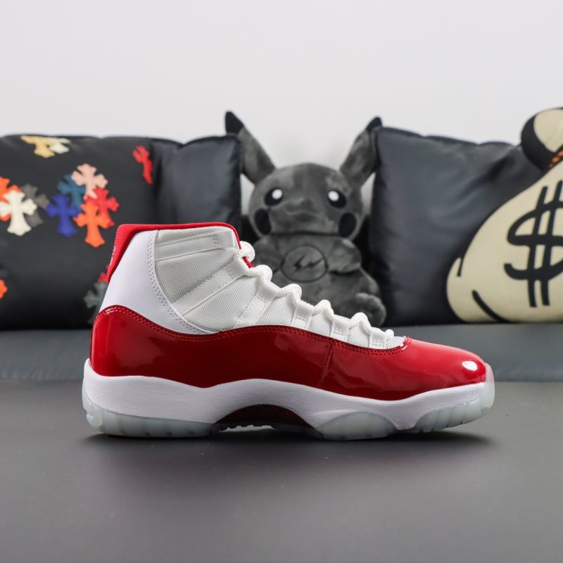 Side view of Jordan 11 Cherry reps in white and varsity red combination