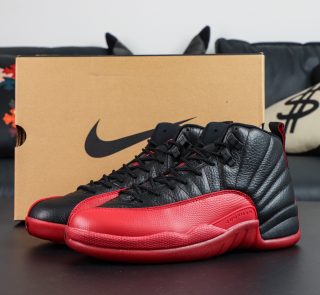 Jordan 12 Flu Game 2025 reps with black and red upper beside retail-style box