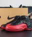 Jordan 12 Flu Game 2025 reps with black and red upper beside retail-style box