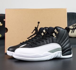 Jordan 12 Playoffs reps with black leather upper and white outsole beside box