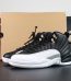 Jordan 12 Playoffs reps with black leather upper and white outsole beside box