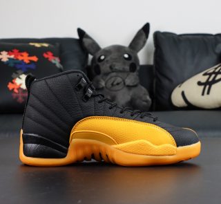 Inner side of Jordan 12 University Gold reps with leather texture and gold accent