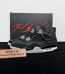 Jordan 4 Black Canvas Reps with box displayed on table