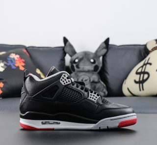 Side view of Jordan 4 Bred Reimagined reps with red midsole accents