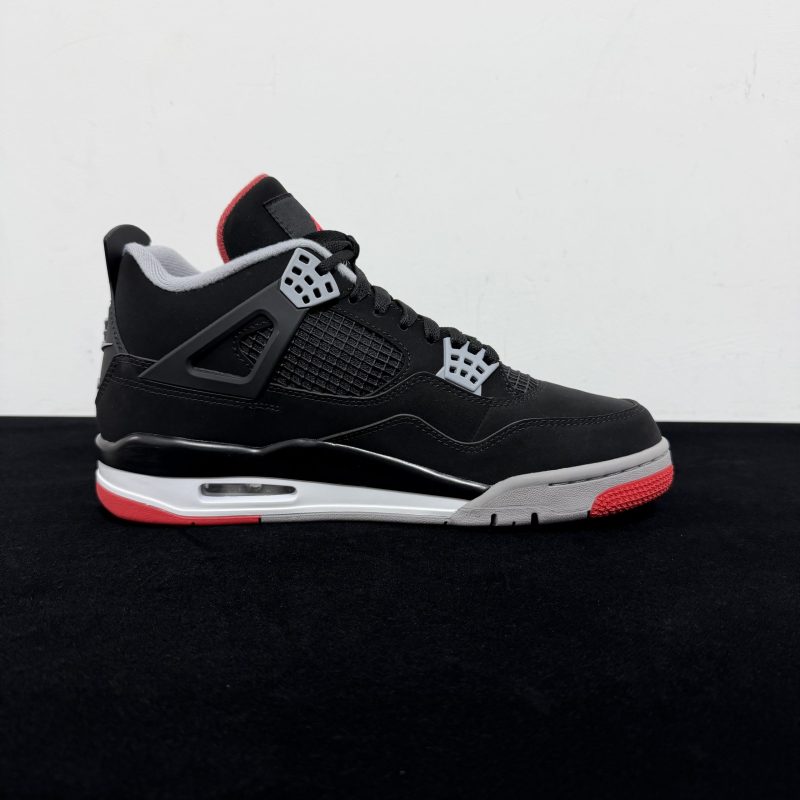 Medial side view of Jordan 4 Bred Reps with mesh panels