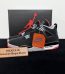 Jordan 4 Bred Reps with box displayed on table