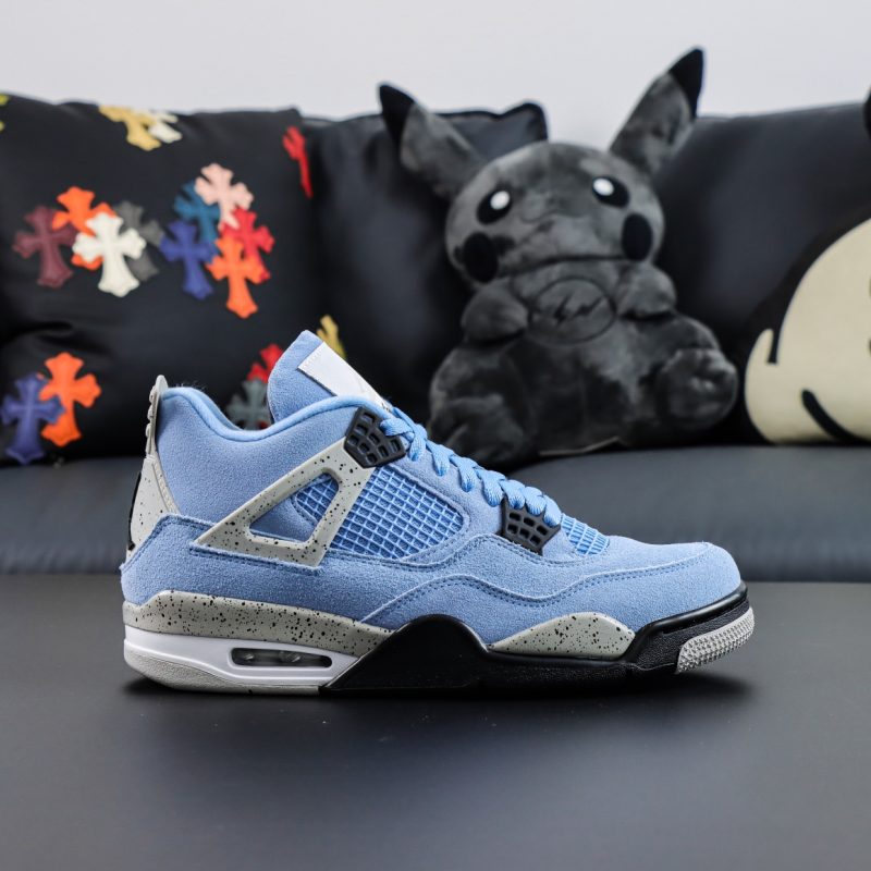 Side view of Jordan 4 University Blue reps showing UNC blue suede and grey speckled wings