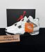 Jordan 4 White Cement 2025 Reps with box displayed on table