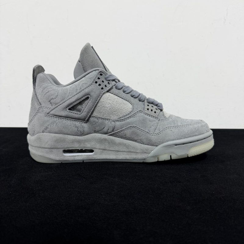 Medial side view of KAWS Jordan 4 Grey Reps with hand graphics