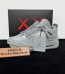 KAWS Jordan 4 Grey Reps with box displayed on table
