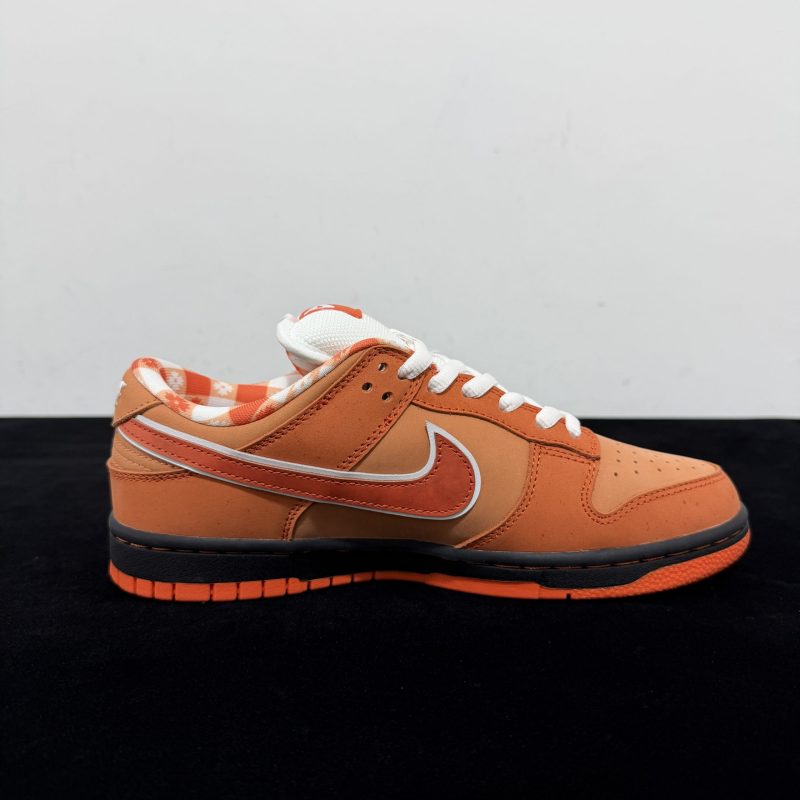 Inside view of Orange Lobster Dunks Reps with speckled orange panel details
