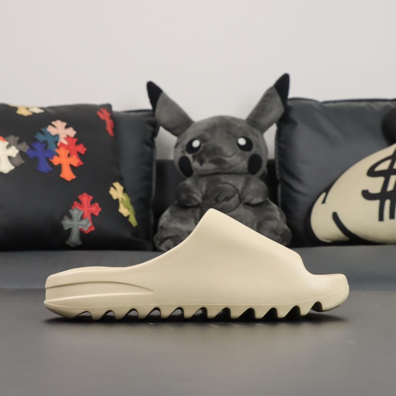 Single shoe side view of Yeezy Slide Bone in beige EVA