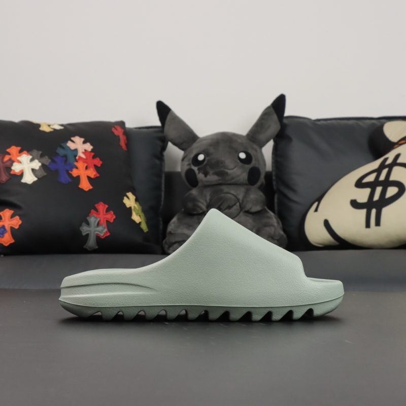 Single shoe side view of Yeezy Slide Salt in light grey